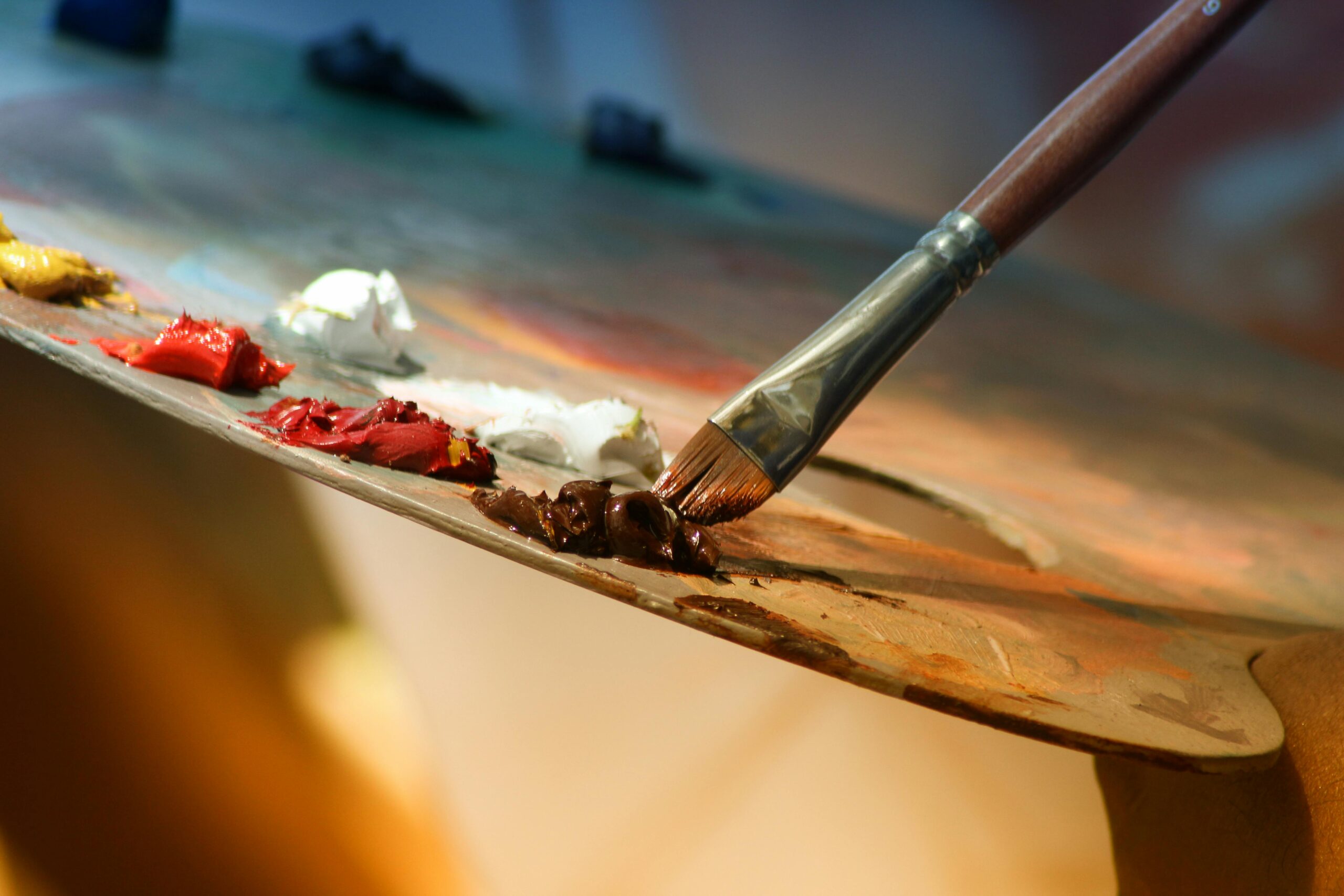 Home Vibrant artist palette with paint and brush creating colorful artwork.
